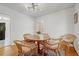 Bright dining room featuring a modern light fixture, hardwood floors, and a round table with seating for five at 1544 Brewer Sw Blvd, Atlanta, GA 30310