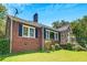 Charming brick home with stone accents, well-maintained lawn, and ample natural light at 1544 Brewer Sw Blvd, Atlanta, GA 30310