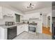 A kitchen featuring white cabinets, stainless steel appliances, and tile flooring at 1544 Brewer Sw Blvd, Atlanta, GA 30310
