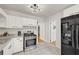 A bright kitchen features a gas range, black refrigerator and tile floors at 1544 Brewer Sw Blvd, Atlanta, GA 30310