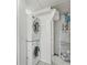 Functional laundry area with stacked washer/dryer, water heater and storage potential at 1544 Brewer Sw Blvd, Atlanta, GA 30310