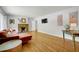 Spacious living room featuring a stone fireplace, hardwood floors, and abundant natural light at 1544 Brewer Sw Blvd, Atlanta, GA 30310