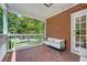 Covered porch with comfortable seating, a brick wall, and a view of the outdoors at 1544 Brewer Sw Blvd, Atlanta, GA 30310