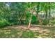 A wooden swing set in a lush backyard is perfect for outdoor fun and relaxation at 1716 Beacon Hill Ne Blvd, Atlanta, GA 30329