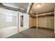 Partially finished basement with carpeted and bare floors and a glass block window at 1716 Beacon Hill Ne Blvd, Atlanta, GA 30329
