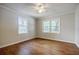 Bedroom featuring hardwood floors, neutral paint, and dual windows at 1716 Beacon Hill Ne Blvd, Atlanta, GA 30329