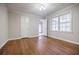 Bright bedroom with hardwood floors, neutral paint, and windows at 1716 Beacon Hill Ne Blvd, Atlanta, GA 30329