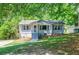 Charming single story home with a well maintained lawn, a few steps and trees in front at 1716 Beacon Hill Ne Blvd, Atlanta, GA 30329