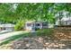 Charming home with gray siding, landscaping and a well-manicured lawn at 1716 Beacon Hill Ne Blvd, Atlanta, GA 30329