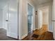 Hallway with hardwood flooring and multiple doorways, and an extinguisher at 1716 Beacon Hill Ne Blvd, Atlanta, GA 30329