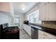 Bright kitchen featuring white cabinets, stainless steel appliances, and tile flooring at 1716 Beacon Hill Ne Blvd, Atlanta, GA 30329