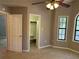 Bedroom featuring a ceiling fan, closet, and bright windows for natural light at 4433 Ford Pl, Snellville, GA 30039