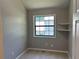 This bedroom features a window for natural light and built-in shelving for storage and organization at 4433 Ford Pl, Snellville, GA 30039