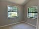 Bedroom featuring neutral paint, carpet, and bright windows for natural light at 4433 Ford Pl, Snellville, GA 30039