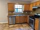 Kitchen with stainless steel appliances, wood cabinets, and a window over the sink at 4433 Ford Pl, Snellville, GA 30039