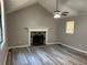 Spacious living room featuring a stone fireplace, vaulted ceiling, and modern gray flooring at 4433 Ford Pl, Snellville, GA 30039