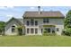 A large backyard area shows a home with several windows and a generous lawn at 543 Serene Waters Trl, Jonesboro, GA 30236