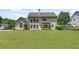 Large backyard featuring expansive green space and a home with multiple windows at 543 Serene Waters Trl, Jonesboro, GA 30236