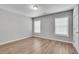 Bedroom featuring wood floor, two windows that provide natural light and neutral paint at 543 Serene Waters Trl, Jonesboro, GA 30236