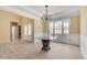 Elegant dining room features bright window, decorative chandelier, and white wainscoting at 543 Serene Waters Trl, Jonesboro, GA 30236