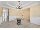 Bright dining room showcases stylish chandelier, white wainscoting and an elegant table at 543 Serene Waters Trl, Jonesboro, GA 30236