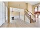 Welcoming entryway with hardwood floors, staircase, and an adjacent dining area at 543 Serene Waters Trl, Jonesboro, GA 30236