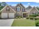 Traditional brick home with manicured lawn, lush landscaping and a two car garage at 543 Serene Waters Trl, Jonesboro, GA 30236