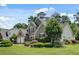 Beautiful brick home boasts a well-maintained lawn, mature trees, and lush landscaping for a serene setting at 543 Serene Waters Trl, Jonesboro, GA 30236