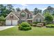 Charming brick home with a well-manicured lawn and lush landscaping creates excellent curb appeal at 543 Serene Waters Trl, Jonesboro, GA 30236