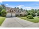Beautiful brick home with an attached two-car garage and a long driveway on a sunny day at 543 Serene Waters Trl, Jonesboro, GA 30236