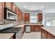 Bright kitchen features stainless steel appliances, stone backsplash, and large countertops at 543 Serene Waters Trl, Jonesboro, GA 30236