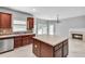 Bright kitchen features stainless appliances, large island, and breakfast area with fireplace at 543 Serene Waters Trl, Jonesboro, GA 30236