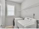 Bright laundry room equipped with washer, dryer, and wire shelving at 543 Serene Waters Trl, Jonesboro, GA 30236