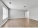 Spacious living room with wood flooring, window and door leading to other room at 543 Serene Waters Trl, Jonesboro, GA 30236