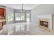 Open living room with fireplace, large windows and lots of natural light at 543 Serene Waters Trl, Jonesboro, GA 30236
