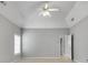 Spacious primary bedroom with a ceiling fan, large windows and neutral colors at 543 Serene Waters Trl, Jonesboro, GA 30236