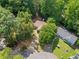 Aerial view of a secluded home nestled among lush, mature trees at 10650 Colony Glen Dr, Johns Creek, GA 30022