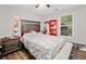 This bedroom features a ceiling fan, wood floors, and bright window views at 10650 Colony Glen Dr, Johns Creek, GA 30022
