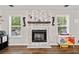 Cozy living room featuring a decorative fireplace with stone surround and dark wood mantel at 10650 Colony Glen Dr, Johns Creek, GA 30022