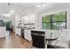 Eat-in kitchen with stainless steel appliances, granite countertops, and modern lighting at 10650 Colony Glen Dr, Johns Creek, GA 30022