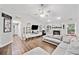 Bright living room with fireplace, tv, ceiling fan, hardwood flooring, and lots of space at 10650 Colony Glen Dr, Johns Creek, GA 30022