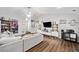 Open-concept living room featuring stylish decor, modern lighting, and laminate wood flooring at 10650 Colony Glen Dr, Johns Creek, GA 30022