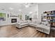 Spacious living room with fireplace, ceiling fan, wood flooring, and abundant natural light at 10650 Colony Glen Dr, Johns Creek, GA 30022
