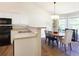 Cozy dining area adjacent to the kitchen, featuring a chandelier and views of the backyard at 2577 Abbotts Glen Nw Dr, Acworth, GA 30101