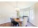 Cozy dining room featuring a wood table, decorative chandelier, and views from bright windows at 2577 Abbotts Glen Nw Dr, Acworth, GA 30101