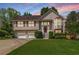 Charming two-story home with a well-manicured lawn, attached garage, and a welcoming front porch at 2577 Abbotts Glen Nw Dr, Acworth, GA 30101
