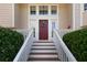 Inviting front entrance featuring a red door, white railings, and neatly trimmed bushes at 2577 Abbotts Glen Nw Dr, Acworth, GA 30101