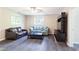 Cozy living room featuring wood flooring, multiple windows and comfortable furnishings at 2577 Abbotts Glen Nw Dr, Acworth, GA 30101