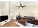 Spacious living room featuring vaulted ceiling, fan, wood floors, and comfortable seating at 2577 Abbotts Glen Nw Dr, Acworth, GA 30101
