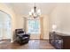 Inviting living room with dark wood floors, accent wall, and lots of natural light at 2577 Abbotts Glen Nw Dr, Acworth, GA 30101